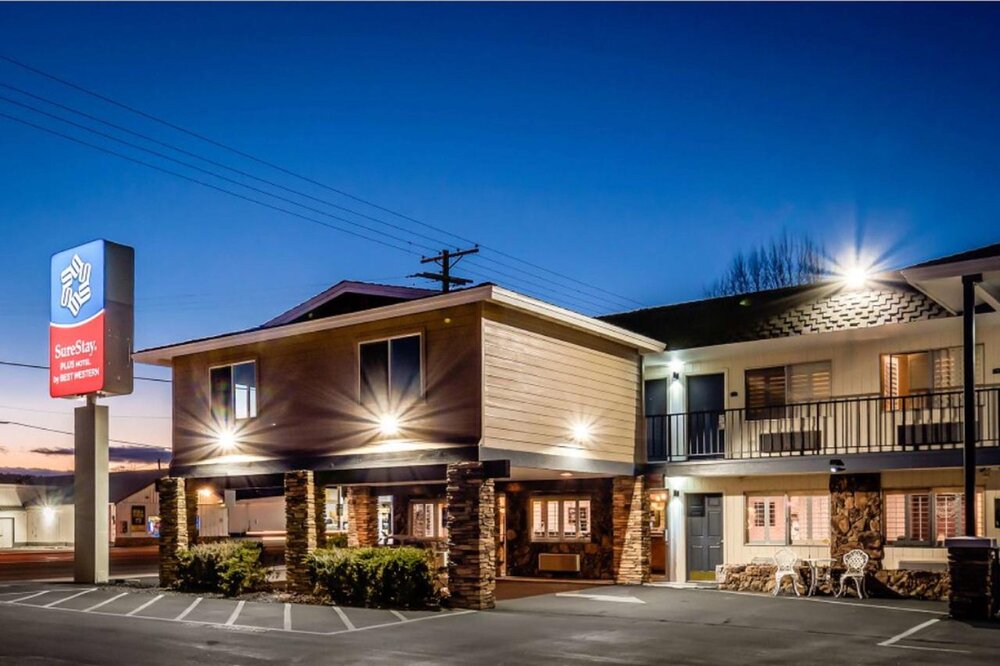 SureStay Plus by Best Western hotel exterior at dusk with illuminated sign