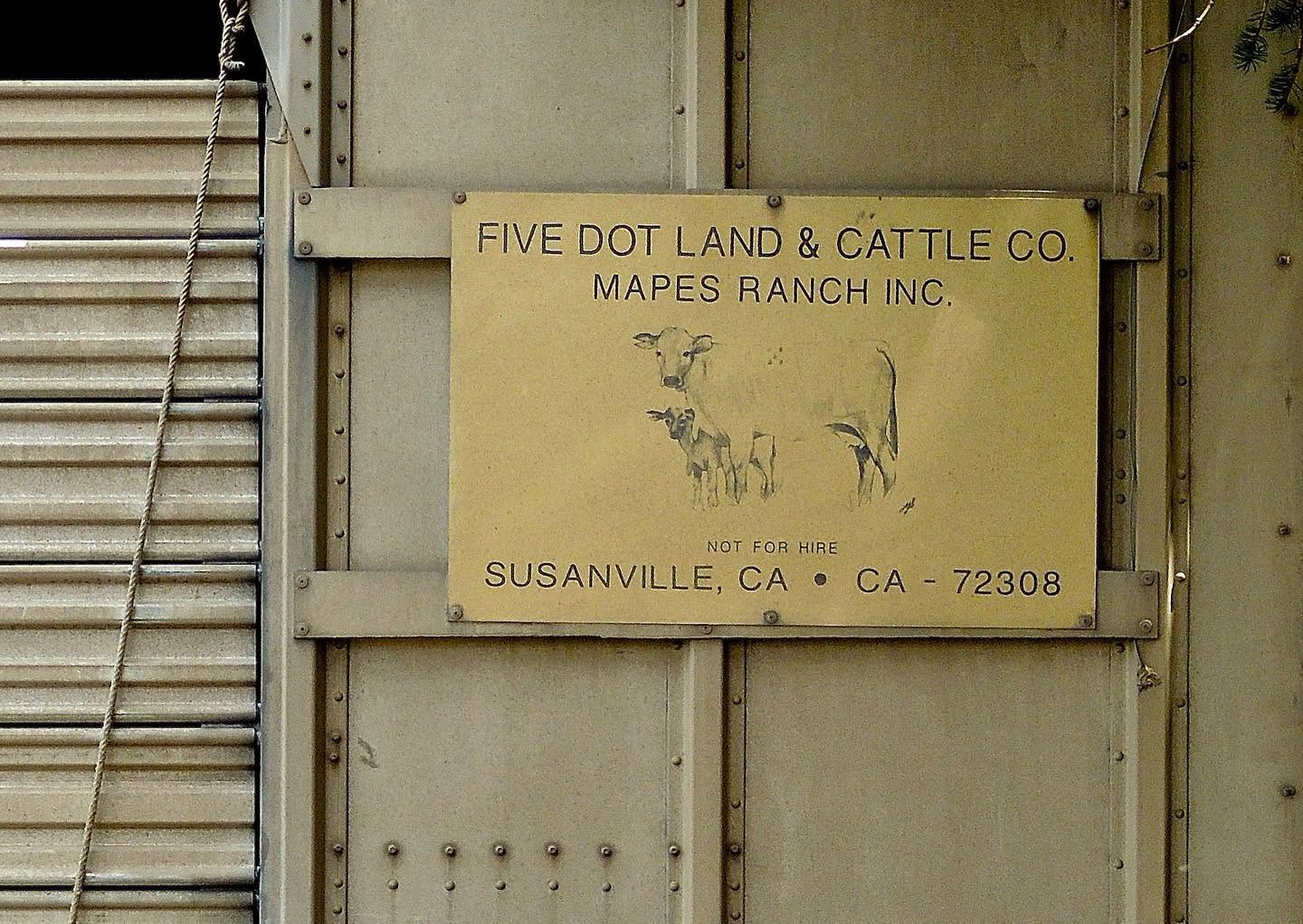 A metal ranch sign reading Five Dot Land and Cattle Co., Mapes Ranch Inc., Susanville, CA